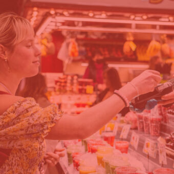 Woman paying with credit card via terminal on bazaar